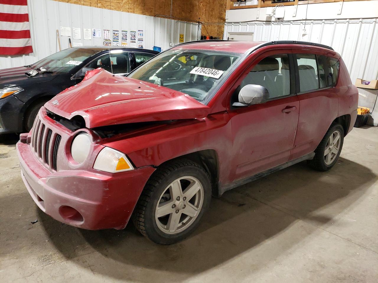 2010 Jeep Compass VIN 1J4NF4FB9AD601674 photo 1